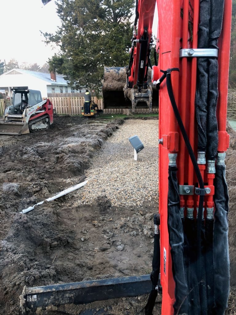 Excavation equipment at work laying gravel